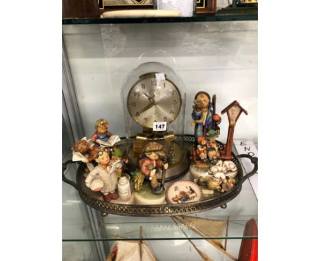 A JUNGHANS ELECTRIC CLOCK TOGETHER WITH HUMMEL FIGURES ON AN ELECTROPLATE OVAL TRAY