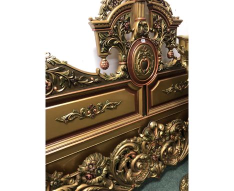 AN IMPRESSIVE CARVED AND GILT DECORATED DOUBLE BED HEADBOARD AND FOOT. 