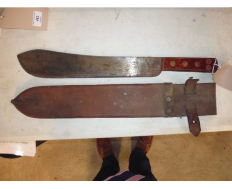 A wooden handled machete with leather case