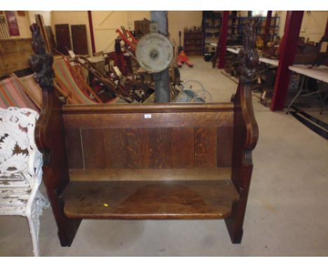An oak pew with number 43, and Free plaque to one end; and number 15 and Free plaque on the other end 