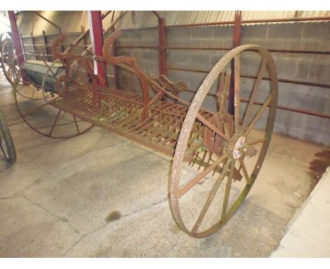 A Ransomes horsedrawn hay rake with 8ft sweep and seat 