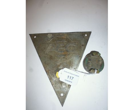 An AEC triangular plaque; and a BP petrol can cap