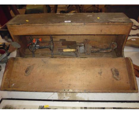An old tool box containing tools; a horse bit etc.