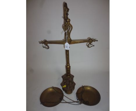 A brass hanging scale and weights (some missing)