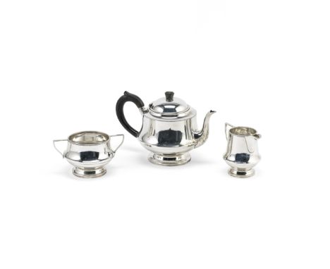 An Art Deco silver three-piece tea serviceA L Davenport, Birmingham 1933 Circular plain form with gently tapering body and be