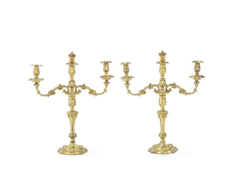 A pair of mid Victorian gilt copper three light candelabrain the Neo-Rococo style the detachable foliate scrolling arms suppo