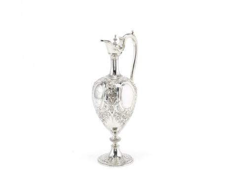 A Victorian silver presentation claret jugWilliam Hunter, London 1863 Slender baluster form with elongated neck featuring fle