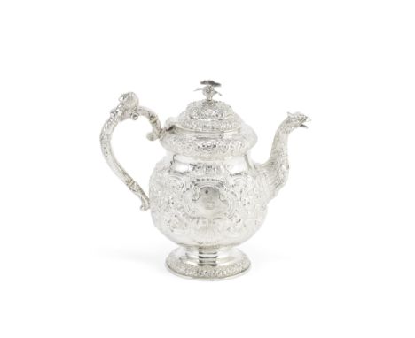 A George IV Irish large silver teapotEdward Power, Dublin 1823 Of globular form with domed upper body, profusely chased and e