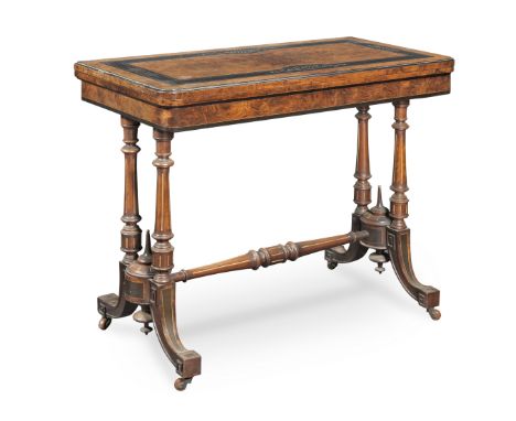 A late Victorian walnut and ebonised card tableThe swivel hinged top incised with stylised foliage, with fluted ring turned c