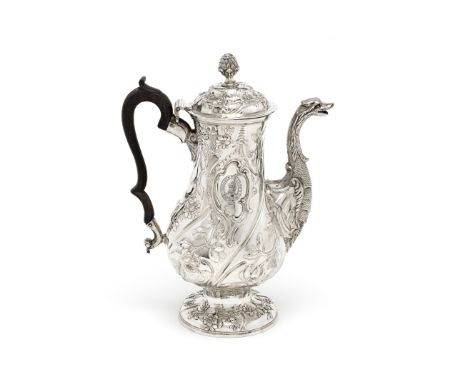 An 18th century Irish silver rococo coffee potJohn St John, Dublin, circa 1765 Baluster form, profusely chased with trailing 
