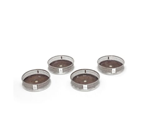 A set of four George III silver wine coastersEdward Lowe, London circa 1777 maker's mark only visible on one and date marks r