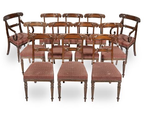 A set of eighteen mahogany and ebonised dining chairsin the Regency style Including two armchairs, each with an acanthus wrap