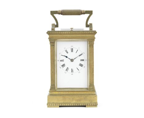 An early 20th century brass carriage clock with repeatthe 'l'Anglaise' case of architectural form, with angular reeded swing 