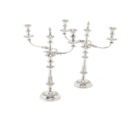 A pair of Old Sheffield plate three-light candelabra, and a pair of candlesticks en suiteKnopped form embellished with foliat