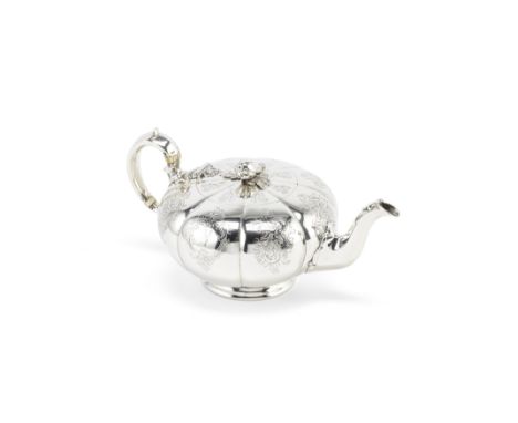 A Victorian silver teapotGeorge Ivory, London 1852 Melon shaped body, engraved with stylised scroll motifs to each panel, one