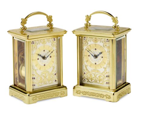 A pair of modern engraved gilt brass carriage timepiecesthe dials signed Igor Carl Fabergéthe Obis cases with curved handles 