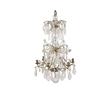 An early 20th century gilt brass and moulded and cut glass six light cage chandelierthe turned nozzles with dished drip pans 
