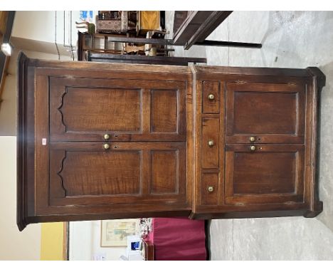 A George III oak standing corner cupboard on bracket feet. 79' high