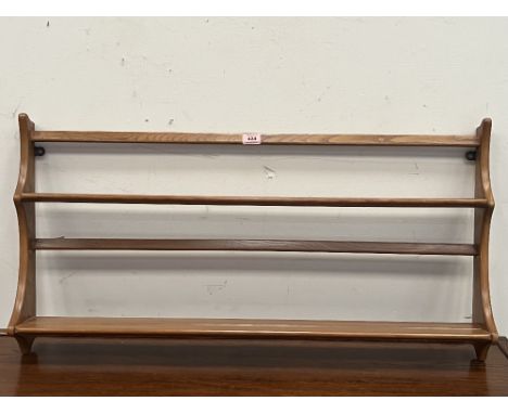 Ercol Furniture. An elm wall hanging plate rack. 38' wide