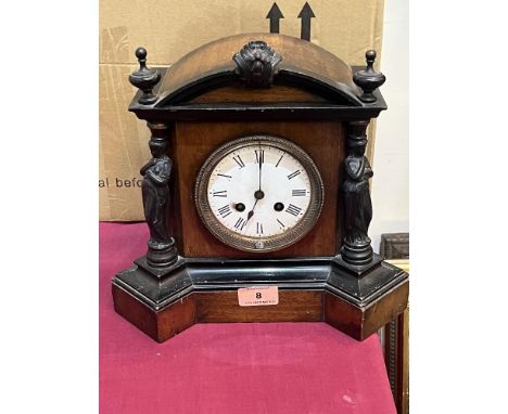 A walnut and ebonised cased mantle clock with French drum movement. 11' high.