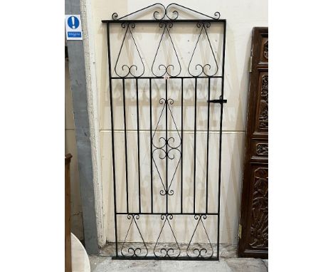 A wrought iron gate 32'w x 74½'h.