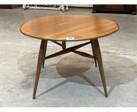 Ercol Furniture. An elm and beechwood drop leaf coffee table. c. 1970. Top damaged