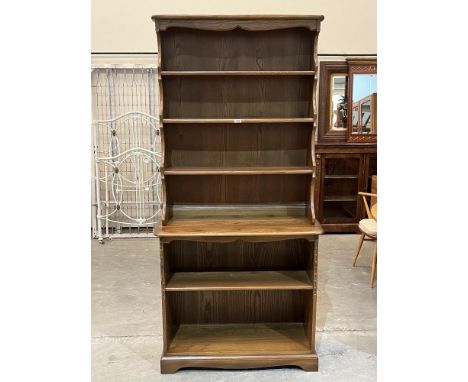 Ercol Furniture. A model 972 elm waterfall bookcase. 36'w x 76'h
