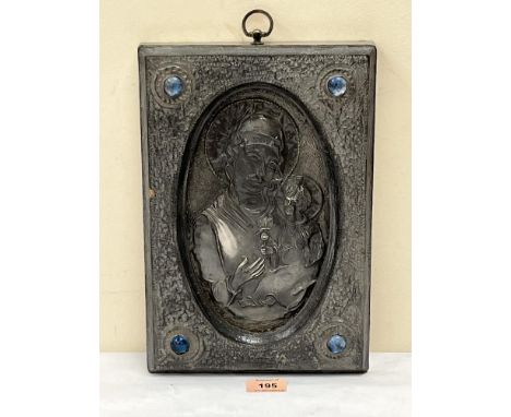 A repousse pewter panel of the Madonna and Christ child with applied blue glass cabochons. 12½' high.