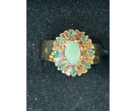 9ct Gold ring set with central opal surrounding by emeralds Size K Weight 4.2g