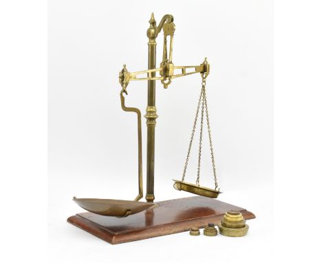 A set of high Victorian brass counter-top shop scales and weights. The scales of typical from supported by a turned brass ste