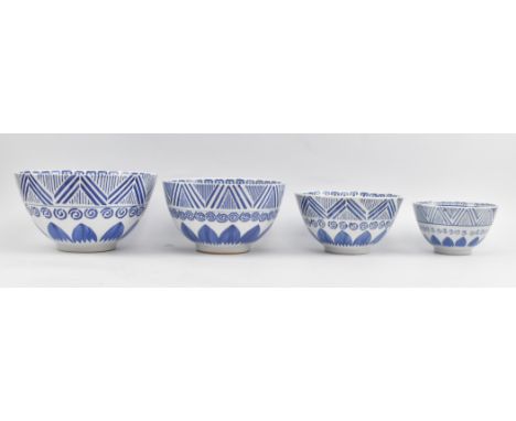 A collection of four 20th century Chinese blue and white graduating bowls. Each bowl is decorated with geometric patterns and