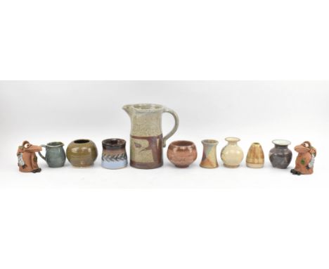 A collection of eleven pieces of vintage studio pottery. The lot comprising talle mottled stoneware jug signed D S, a lidded 