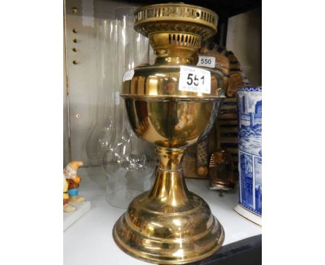 A brass oil lamp base and two glass chimneys. 