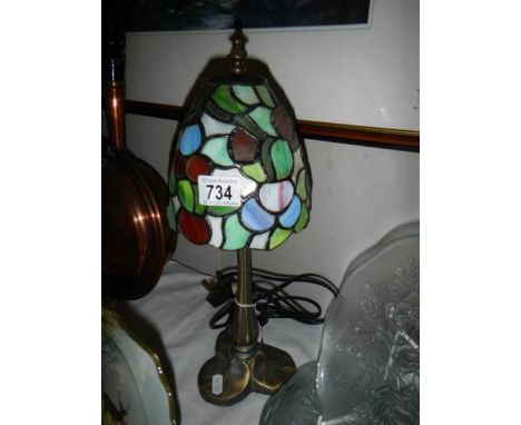 A table lamp with Tiffany style shade. 