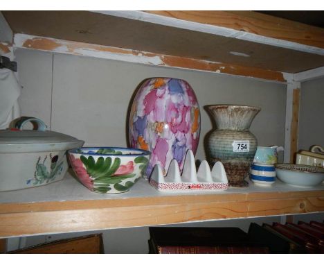 A shelf of miscellaneous ceramics. 