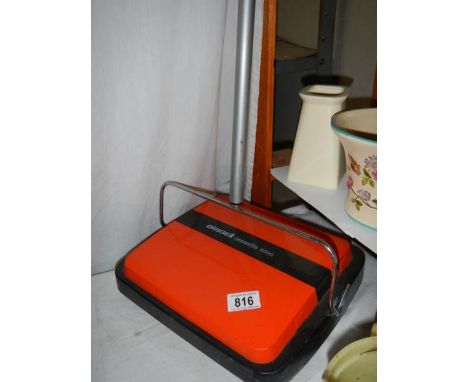 A Bissell carpet sweeper. 
