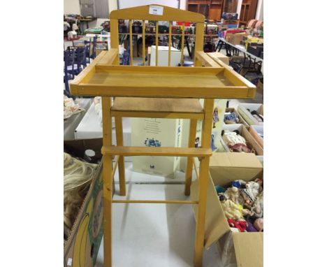 A light wood dolls high chair.