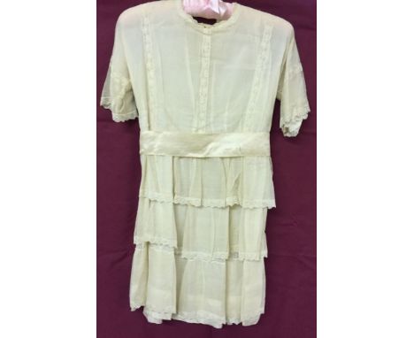 An Edwardian lace childs dress with ribbon sash. Suitable for dolls.