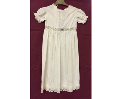 A Victorian christening gown with short sleeves in light cotton. Lace applique to front and hem. Suitable for dolls.