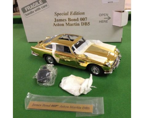 A boxed Danbury Mint Special Edition James Bond 007 gold plated Aston martin DB5 in unused condition. 1:24 scale. No COA