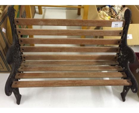 A cast iron ended miniature garden bench for dolls.