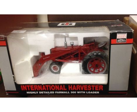 A SpecCast International Harvestor McCormick Farmall 300 tractor with loader. 1/16th scale, in box with original packing.