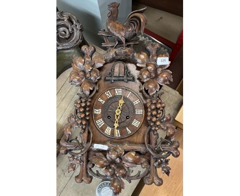 Spring driven Cuckoo clock with carved vine decoration