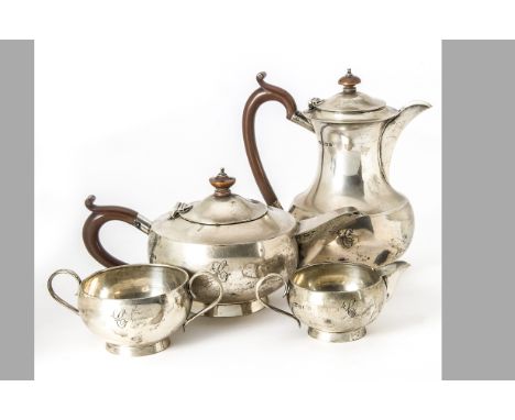 A George V silver four piece silver tea set by S.B. &amp; S Ltd, hot water pot, teapot, sugar basin and milk jug each with en