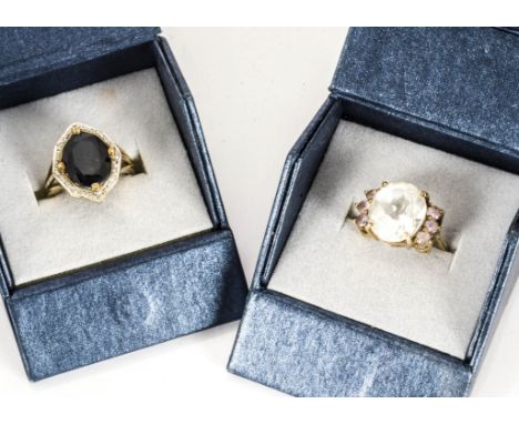 Two gem set dress rings, comprising a sapphire and diamond cluster ring in 9ct gold and silver setting ring size M and a rock