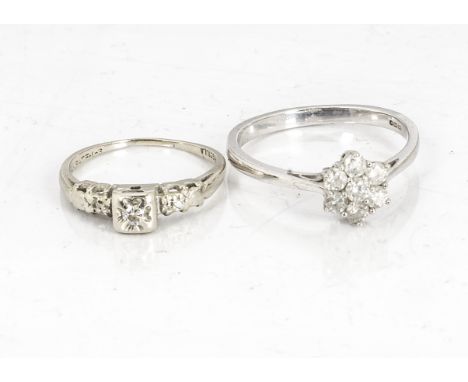 A 9ct gold diamond flower head dress ring, ring size R, together with a 14k marked diamond three stone dress ring, ring size 