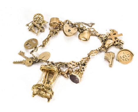 A 9ct gold charm bracelet, including a plastic cased 9ct gold skeleton clock, kettle, cornelian seal, spinning fob spelling I