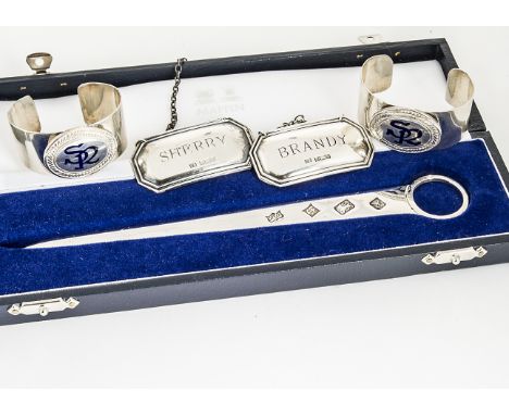 A cased modern silver letter opener from Mappin &amp; Webb, together with a pair of silver napkin holders with blue enamel in