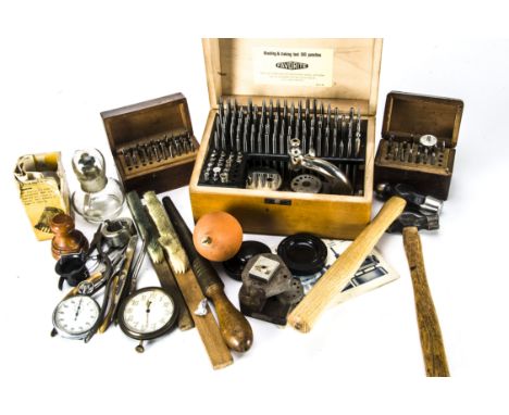 A collection of vintage and modern watch repairing tools and other items, including a Favorite riveting and staking set, alon