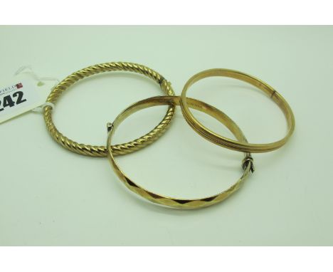 A 9ct Gold Bangle, together with a hallmarked silver gilt bangle, of faceted finish, hinged to snap clasp and another bangle,